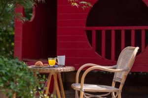 a table with two chairs and a glass of orange juice at ibis Styles Paris Nation Cours de Vincennes in Paris