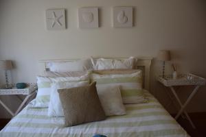 A bed or beds in a room at Tranquillity Beach House