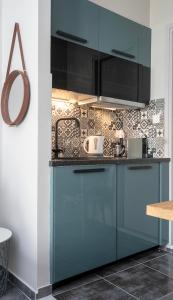 a kitchen with blue cabinets in a room at Yasemi Studio 1 in Heraklio