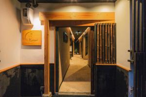 a hallway with an open door to a room at Hazuki Kyoto in Kyoto