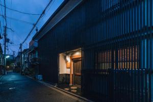 a black building with a door on the side of a street at Hazuki Kyoto in Kyoto
