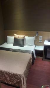 Voodi või voodid majutusasutuse Yung Feng Hotel toas