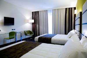 Postel nebo postele na pokoji v ubytování Hotel Napoleon