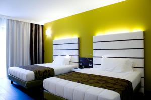 Postel nebo postele na pokoji v ubytování Hotel Napoleon