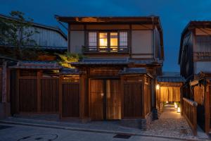 a house with a wooden fence and a gate at Campton Kiyomizu Vacation Rental in Kyoto