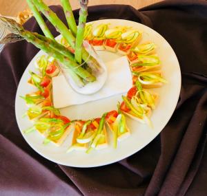 a plate of food with a wreath of vegetables at Hotel de la Lande in Le Brassus