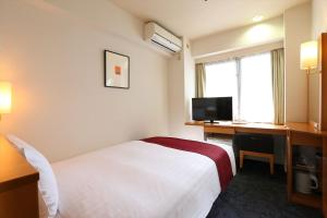 מיטה או מיטות בחדר ב-Hotel Hokke Club Hiroshima