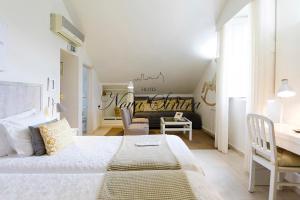 a bedroom with a bed and a desk in a room at Hotel Nova Sintra - Adults only in Sintra