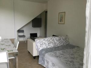 a bedroom with a bed and a table with a chair at Poggio ai Vigneti in Entratico