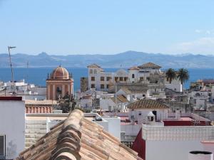 a view of a city from the roofs of buildings at Darcilla Guest House in Tarifa