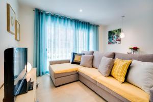 a living room with a couch and a tv at Vivalidays Josep in Blanes