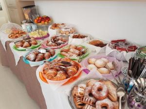 a table with many different types of pastries on it at Hotel Sikania in San Vito lo Capo