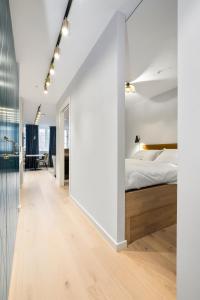 a bedroom with white walls and a bed in a room at VANDER - Sea Story in Stavanger
