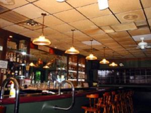 a bar with chairs and lights in a restaurant at Texas Inn in Brownsville