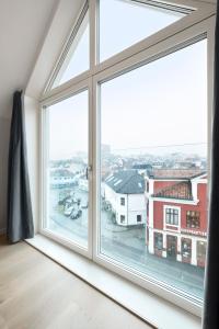 an open window with a view of a city at VANDER - Sea Story in Stavanger
