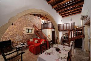 a living room with a table and a red couch at Strofilia Villas Crete in Sellía