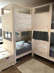 a wooden bunk bed in a room with at Wellenkind Surfschool in La Pared +19 photos