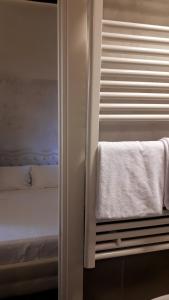a bedroom with a bed and a window with towels at Cà Doge in Venice