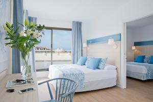 サロウにあるHotel Salou Beach by Pierre & Vacancesのベッドと鏡が備わるホテルルーム