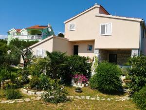 a house with a garden in front of it at Olive grove in Vodice +8 photos