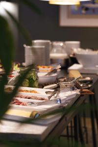 a table with plates of food on top of it at Hotel St. George Helsinki in Helsinki