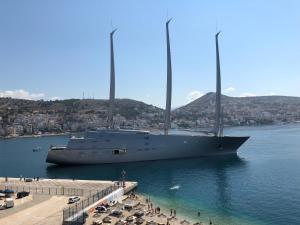 a large boat in the water next to a pier at Port Side Sarande in Sarandë