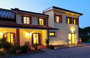 una grande casa bianca con un patio di fronte di Ca' del Faro Bibione a Bibione