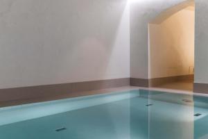 a swimming pool in a room with a floor and a wall at Hotel St. George Helsinki in Helsinki
