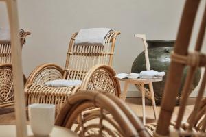 a living room with wicker chairs and a table at Hotel St. George Helsinki in Helsinki