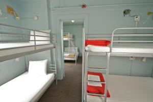Postel nebo postele na pokoji v ubytování American Hotel Hostel