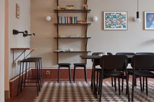 a bar with black chairs and a table in a room at Hotel St. George Helsinki in Helsinki
