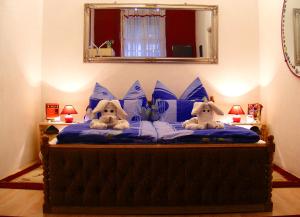 two stuffed animals sitting on top of a bed at Firstapartments Inn City Center in Budapest