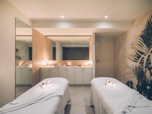 
a bathroom with two sinks and a large mirror at Iberostar Selection Sábila - Adults Only in Adeje
