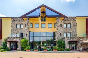 a large stone building with windows and plants at Art & Hotel Aeroporto in Stezzano
