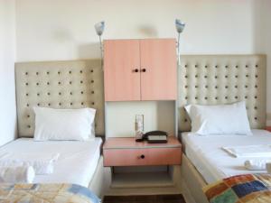 a bedroom with two beds and a nightstand between them at La Santre Villa in Amoudara Herakliou