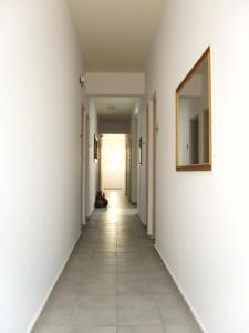a hallway with white walls and a mirror at La Santre Villa in Amoudara Herakliou