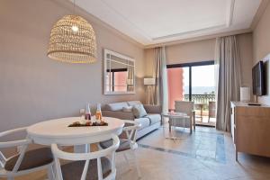 
a living room filled with furniture and a large window at Melia Villaitana in Benidorm
