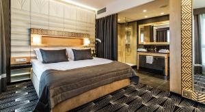 a hotel room with a bed and a bathroom at Airport Hotel Okęcie in Warsaw