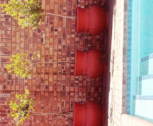 two red traffic lights on the side of a building at New Haven Guest House (Pty) Ltd in Newcastle