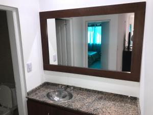 a bathroom with a sink and a mirror at Edificio Tomy in Charata