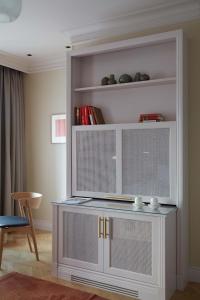 a living room with a white shelf and a table at Hotel St. George Helsinki in Helsinki