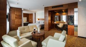 a hotel room with a bed and a desk at Airport Hotel Okęcie in Warsaw