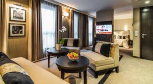 a living room with a couch and a table at Airport Hotel Okęcie in Warsaw