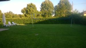 a large lawn with a net and chairs on it at La Casa di Sofia - Casa Vacanza Monterosi in Monterosi