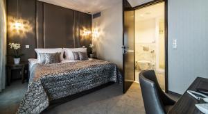 a hotel room with a bed and a bathroom at Airport Hotel Okęcie in Warsaw