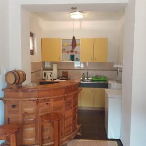 a kitchen with yellow cabinets and a counter top at Guesthouse Ema in Banja Luka
