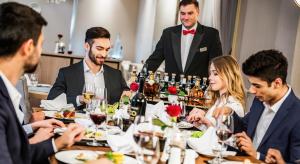 a group of people sitting around a table in a restaurant at Airport Hotel Okęcie in Warsaw