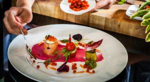 a person eating a plate of food on a table at Airport Hotel Okęcie in Warsaw
