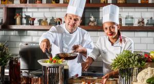 a man and woman in a kitchen preparing food at Airport Hotel Okęcie in Warsaw