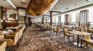 a dining room with tables and chairs at Airport Hotel Okęcie in Warsaw